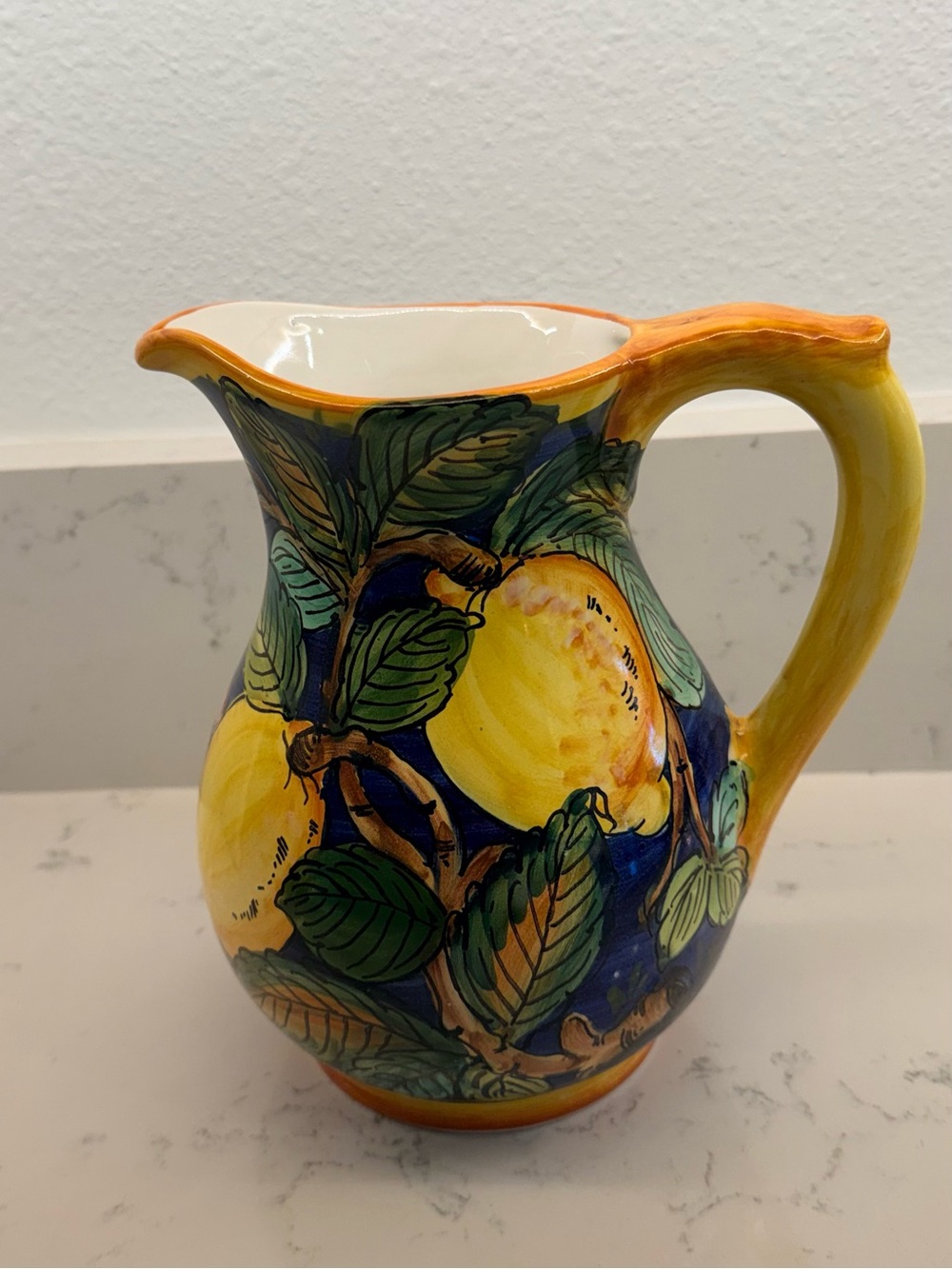 Hand-Painted Yellow Lemon Ceramic Pitcher with Blue Background